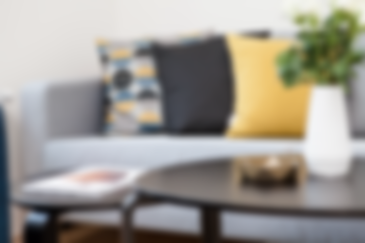 Blurred Image of a Sofa, Coffee Table, and Pillows