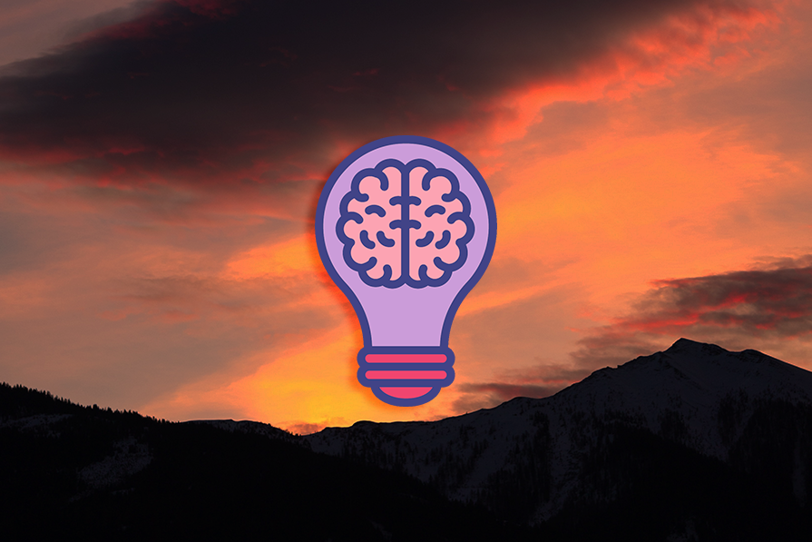Light Bulb with a Brain Icon Over Sunset Background